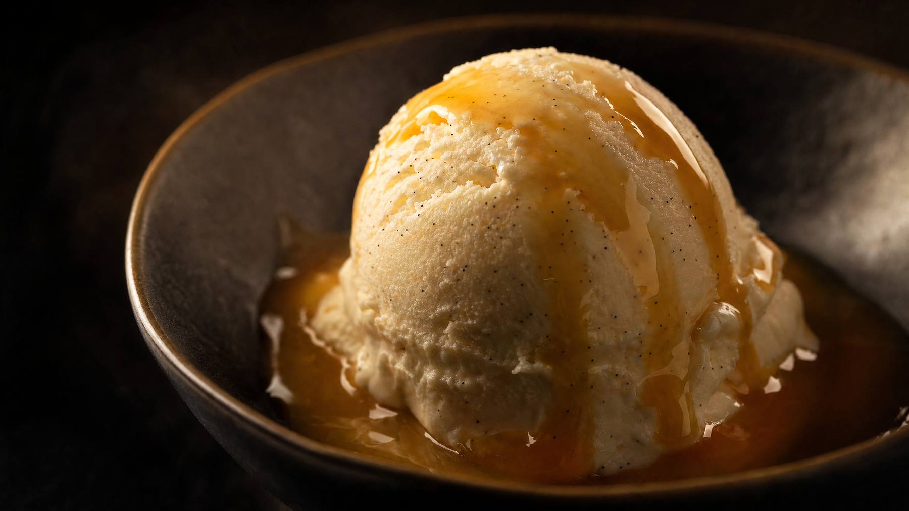 A scoop of creamy ice cream in a waffle cone